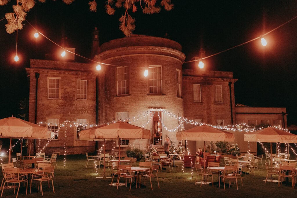 Babington House at night with Festoon lights 